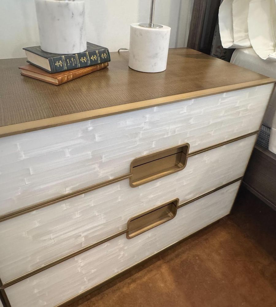 Chest with white stone-look drawer fronts, brass pulls and a wood top