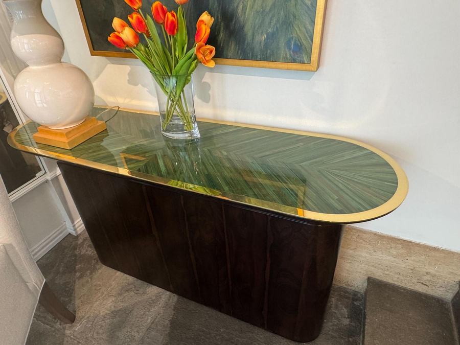 Console with an emerald inlaid top and a vase of orange tulips